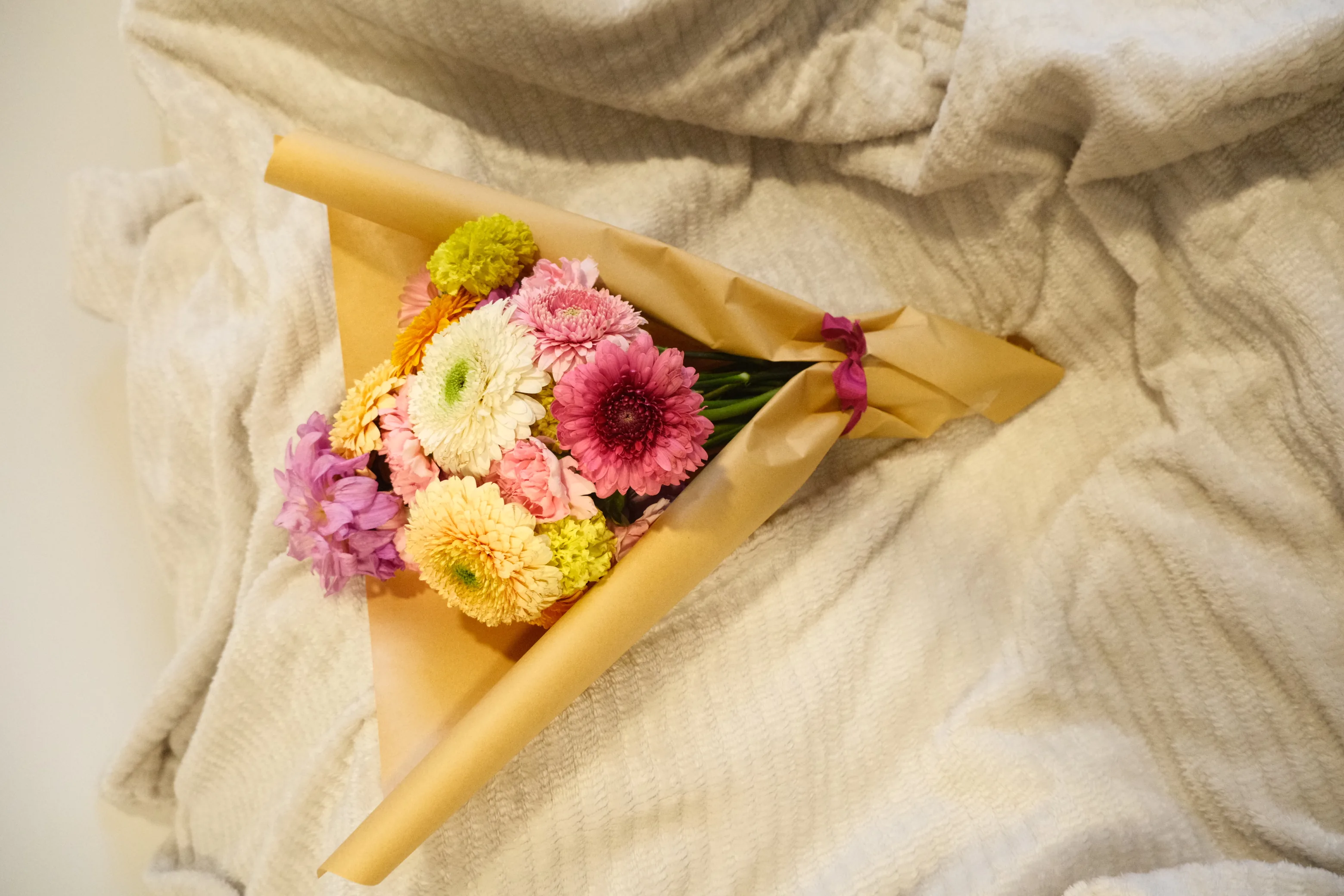 A Maison de Lune bouquet hand-tied in brown paper