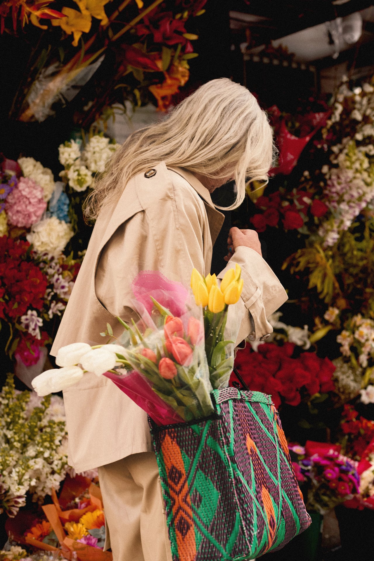 At the flower market, a bouquet of tulips wrapped in white paper