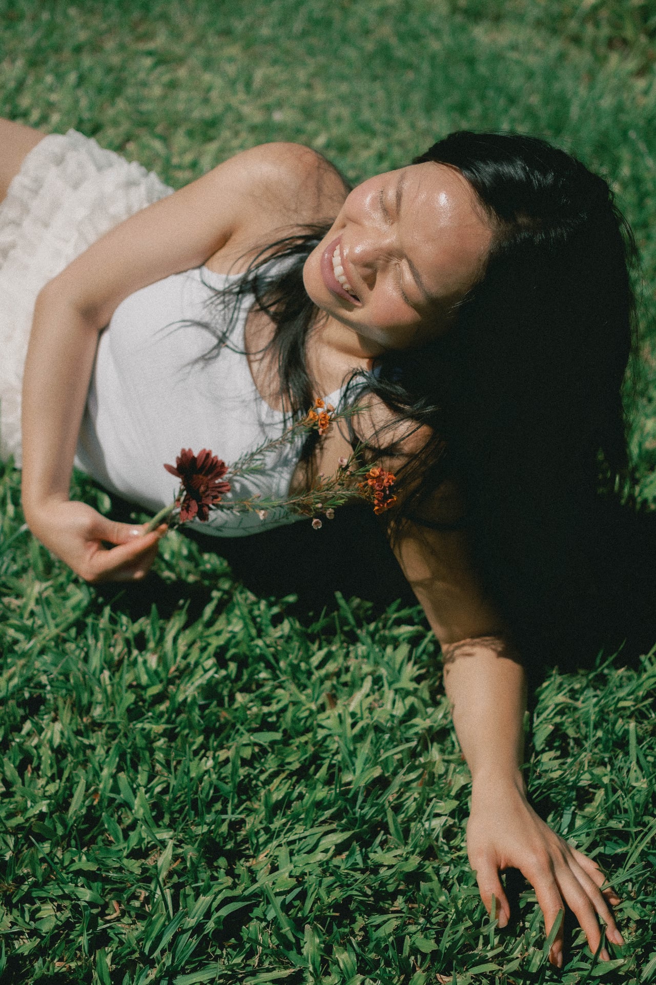 A bright moment in the garden, a small flower in hand