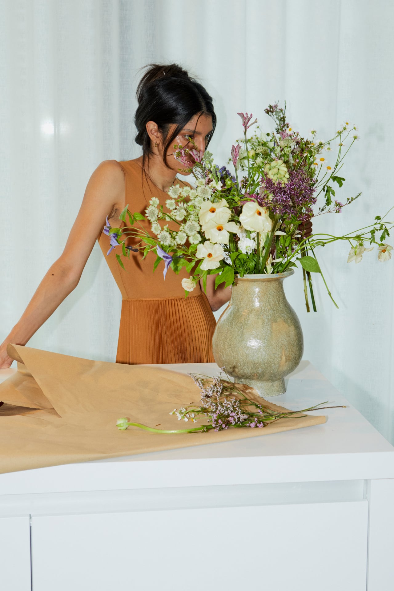 A vase of seasonal flowers on a table at home
