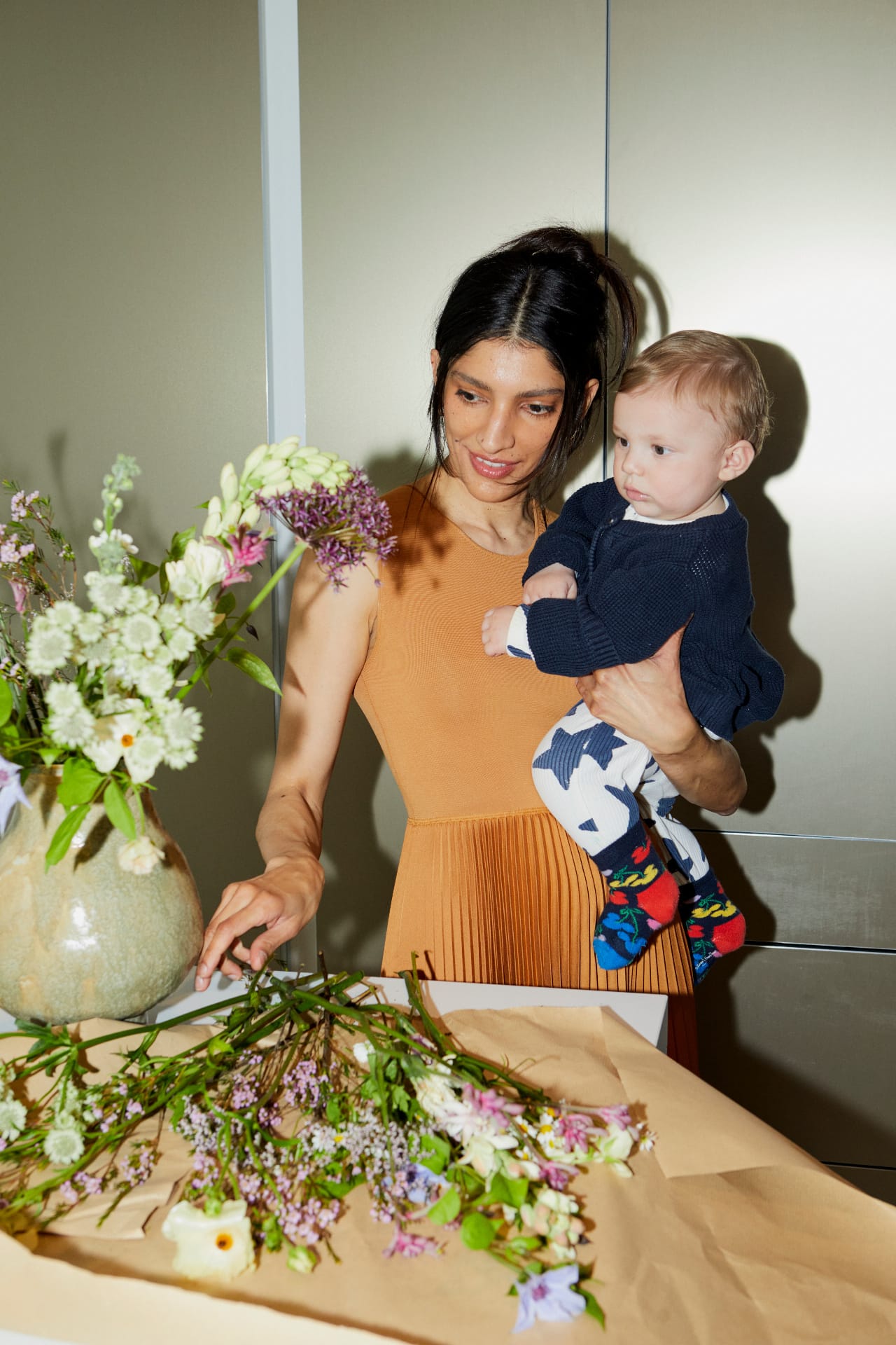 A florist arranging garden flowers at the bench