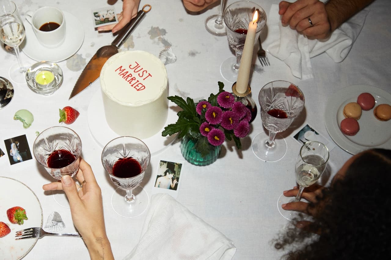 A 'just married' cake on a candlelit dinner table
